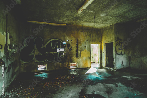 inside of an abandoned and condemned building with graffiti