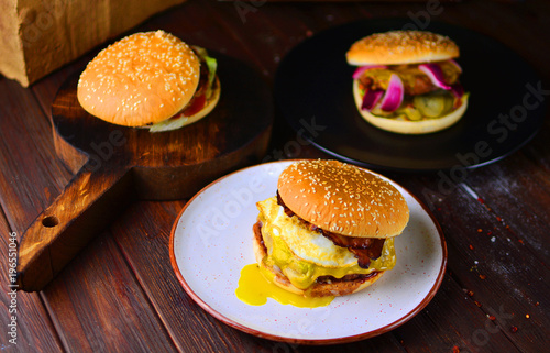 A group of burgers on a table of a restaurant cuisine in a rustic style.