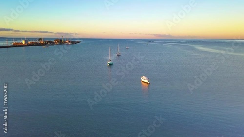 Aerial over boats moored offshore at Kaunakakai Wharf, Molokai, Hawaii.  photo