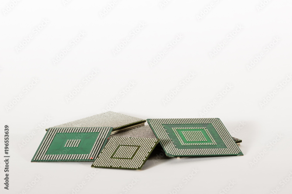 Computer electronic chips isolated on white arranged in a stack. The chips are placed upside down or facing the viewer. there are different chips in the stack Computer electronic chips isolated on white arranged in a stack. The chips are placed upside down or facing the viewer. there are different chips in the stack
