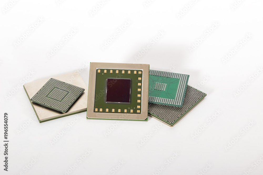 Computer electronic chips isolated on white arranged in a stack. The chips are placed upside down or facing the viewer. there are different chips in the stack Computer electronic chips isolated on white arranged in a stack. The chips are placed upside down or facing the viewer. there are different chips in the stack