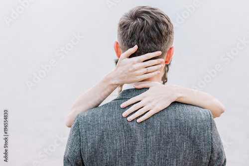 Hugging young couple. Embrace minimal concept.