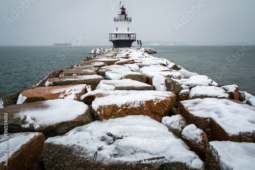 A beautifully snowy lighthouse during a storm in Maine. 