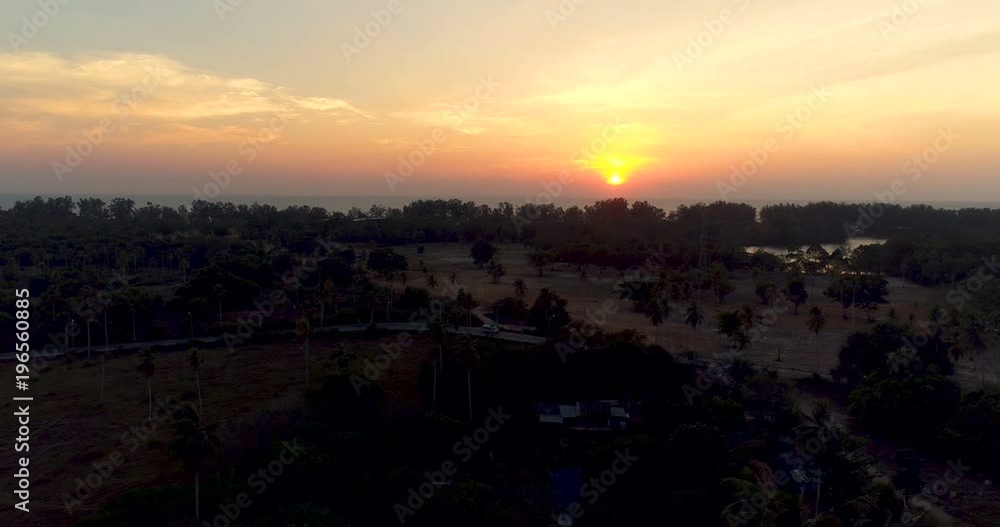 Aerial drone view of road on tropical island during sunset Aerial drone view of road on tropical island during sunset