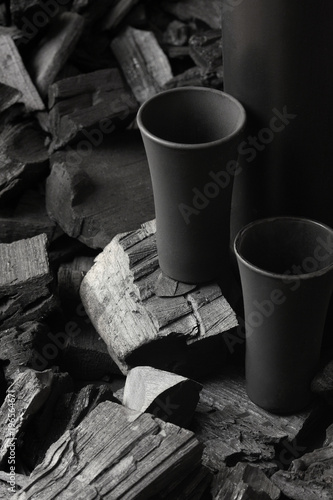 Two matte black shot glass .On charcoal background. Black edition.Creative.Let's drink.Cheers.Mockup.Copy space.Pour it.Still life photo