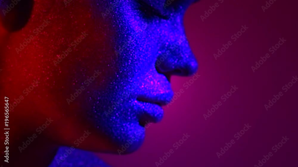 Fashion model woman in colorful bright sparkles and neon lights posing in studio, portrait of beautiful sexy girl. Art design colorful vivid makeup. Slow motion 4K UHD video footage. 3840X2160 Fashion model woman in colorful bright sparkles and neon lights posing in studio, portrait of beautiful sexy girl. Art design colorful vivid makeup. Slow motion 4K UHD video footage. 3840X2160