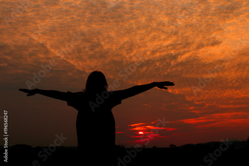 Silhouette of woman exercises at sunset Yellow on sky beautiful in summer