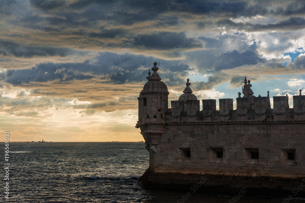 Belem Tower medieval battlement with ocean and wonderful sky at sunset, near Lisbon in Portugal