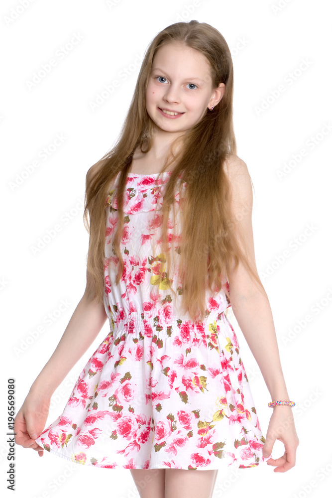 A little girl in a short summer dress. Stock Photo