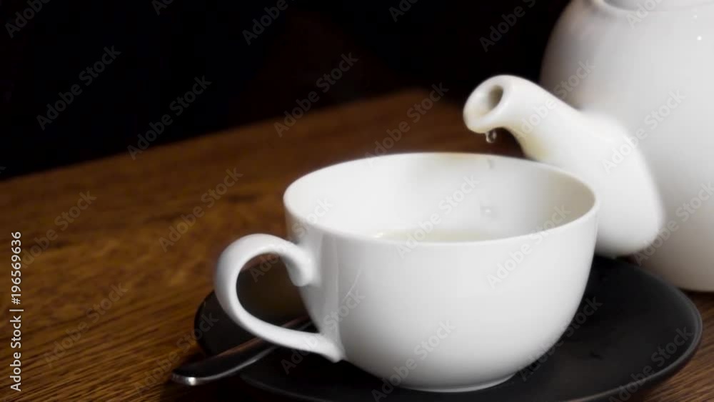 Tea pouring process from a kettle in a mug in slow motion Tea pouring process from a kettle in a mug in slow motion