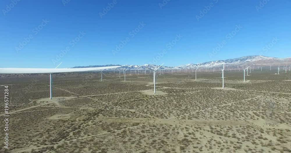 A good eye level aerial over a Mojave desert wind farm as it generates clean energy for California. A good eye level aerial over a Mojave desert wind farm as it generates clean energy for California.
