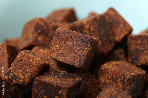 brown cubes of sugar on white background