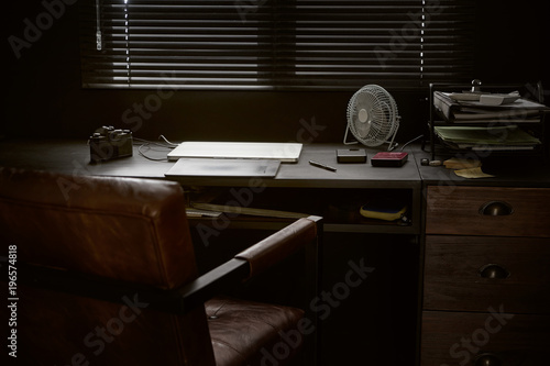 Work space on black table of a photographer or designer with laptop , retro camera and fan , Stylish home studio concept of hipster . Seleted focus. photo