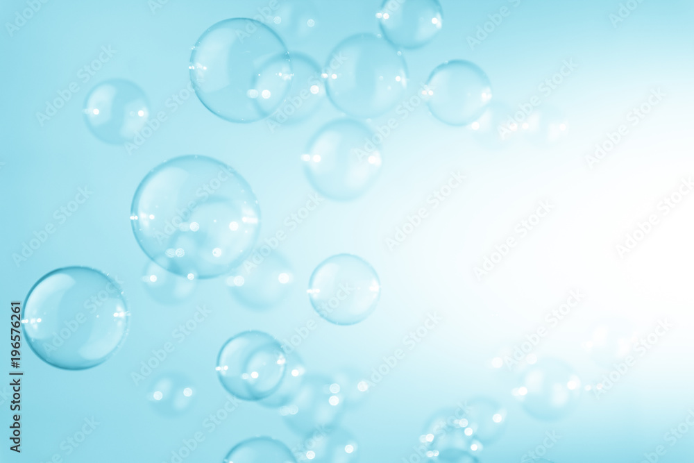 Abstract transparent blue saop bubbles flying in the air. white copy space. soap suds bubbles water