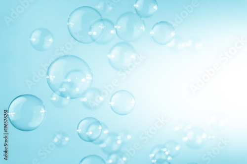 Abstract transparent blue saop bubbles flying in the air. white copy space. soap suds bubbles water