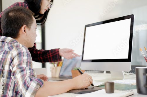 Graphic designer using digital tablet and computer