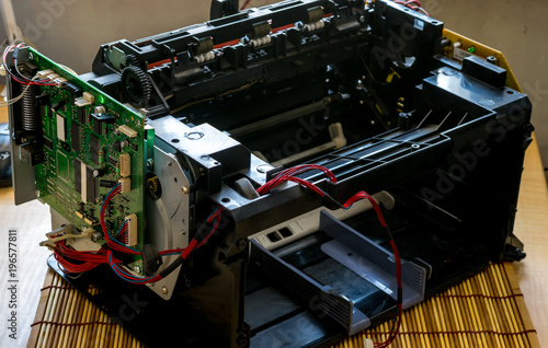laser printer disassembled with the wires and the motherboard