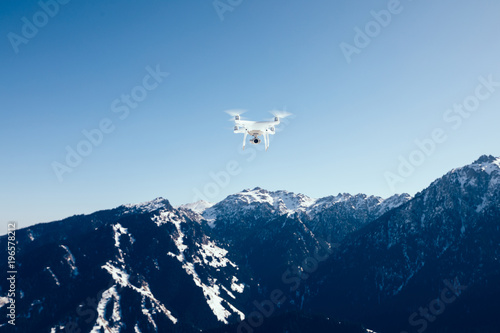 drone flying over winter mountain top