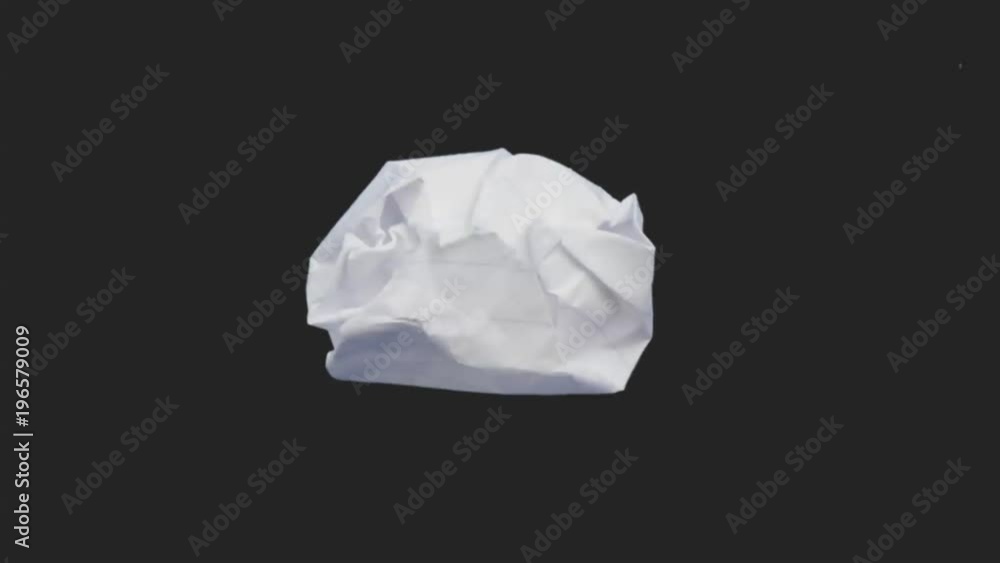 A crumpled piece of paper flattens out.