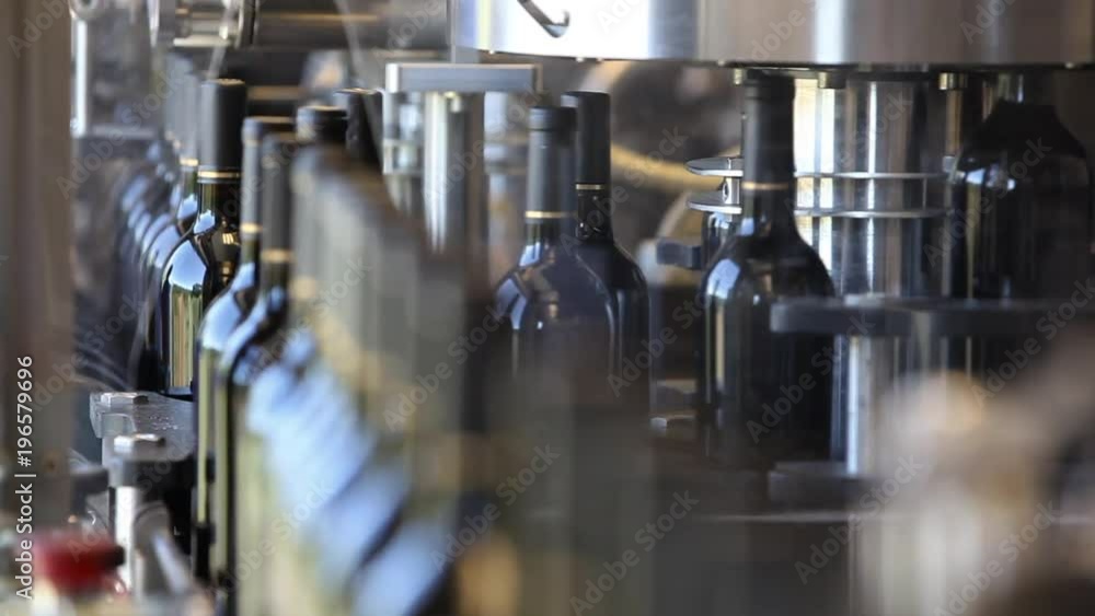 Close up shots of automation along the assembly line inside a wine bottling factory. Close up shots of automation along the assembly line inside a wine bottling factory.