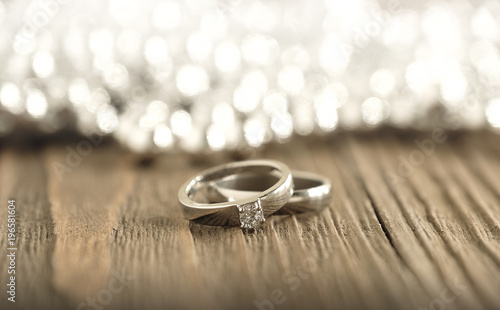 Two wedding rings place on wooden background