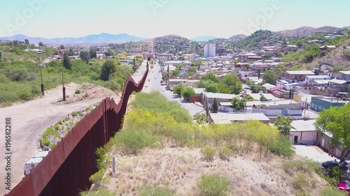 Aerial over a border patrol vehicle standing guard near the border wall at the US Mexico border at Nogales, Arizona. photo