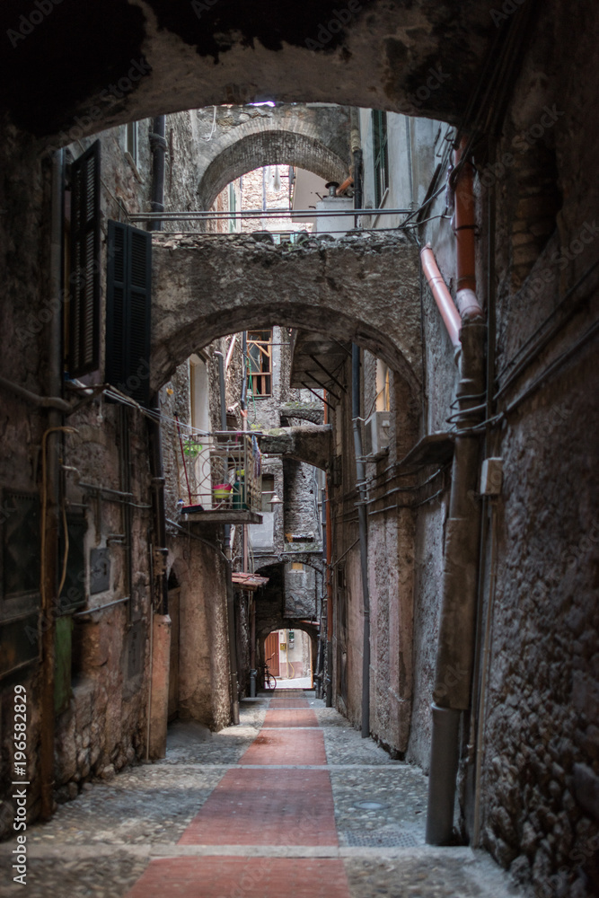 Fototapeta premium The narrow and dark streets of the Italian city of Ventimiglia