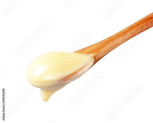 Condensed Milk in wooden spoon 