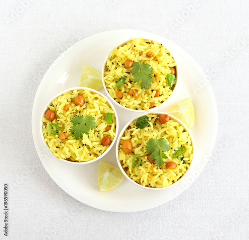 Lemon rice, a south Indian traditional, popular, delicious and vegetarian rice dish, in three bowls.