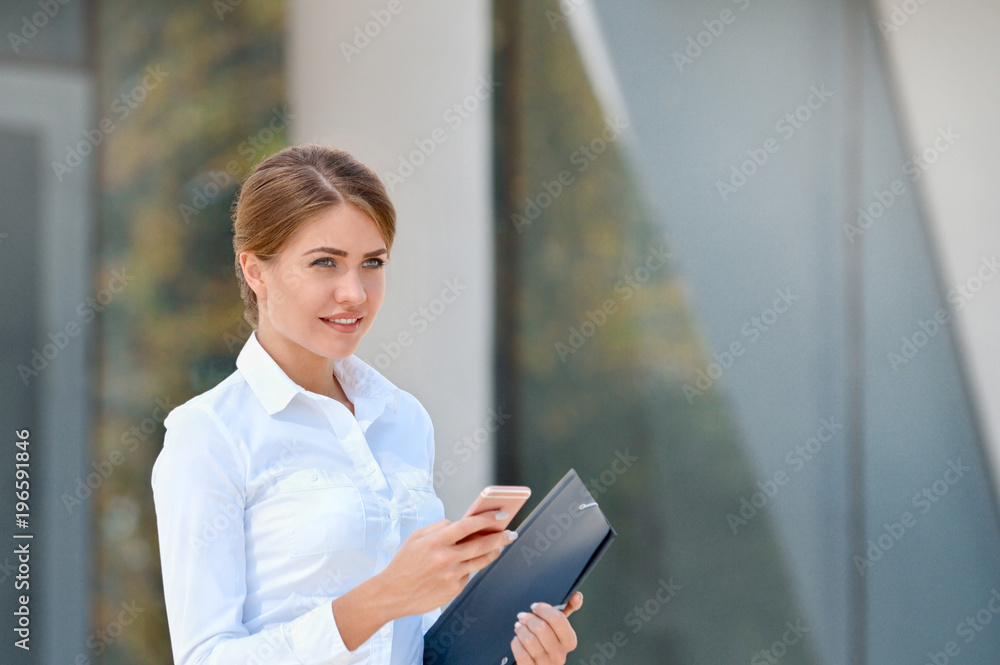 Portrait of cheerful young woman using smartphone outdoors Portrait of cheerful young woman using smartphone outdoors