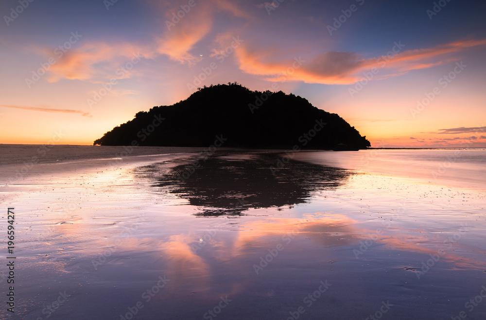 Sunset seascape during blue hour with ray of light.