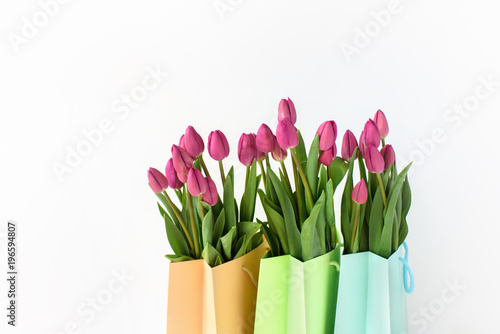 Bouquets of tulips in paper multi-colored packages. Spring gifts. © Anastasiia