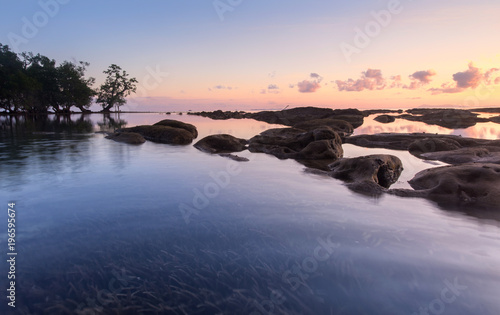 sunset seascape with natural coastal rocks.