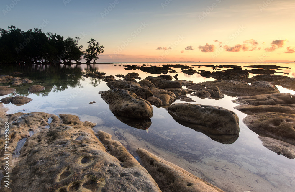 Fototapeta premium Sunset seascape with natural coastal rocks at Kudat, Sabah Malaysia.