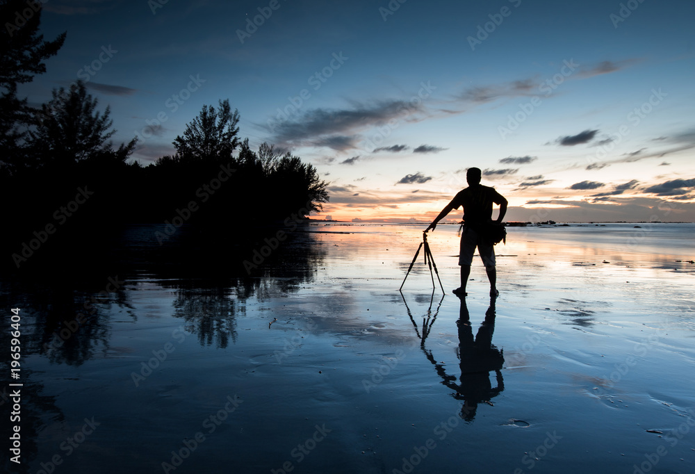 Rear view of a Man with beautiful reflection during sunset at Kudat, Sabah Malaysia.