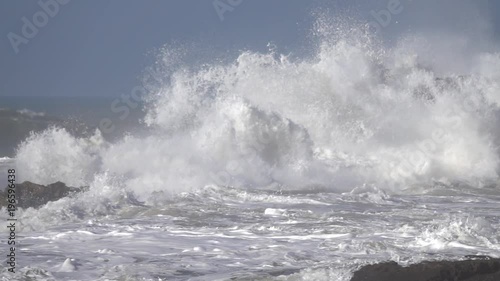 Splashes from atlantic ocean big waves over cliffs, slow motion
