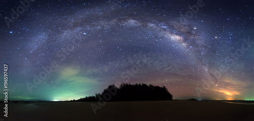 Stitched Panorama milky way rise above tree at Kudat, Sabah Malaysia. image contain soft focus, blur and noise due to long expose and high iso.