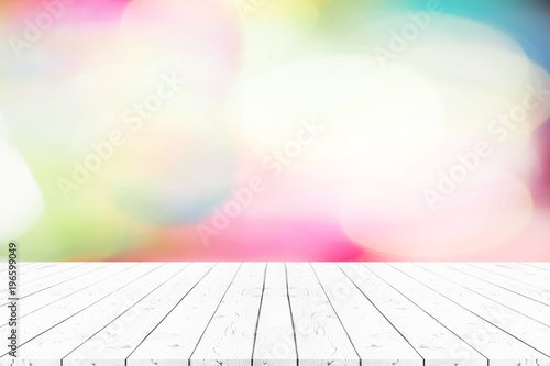 Perspective empty white wooden table on top over blur bokeh colorfull background, can be used mock up for montage products display or design layout. photo