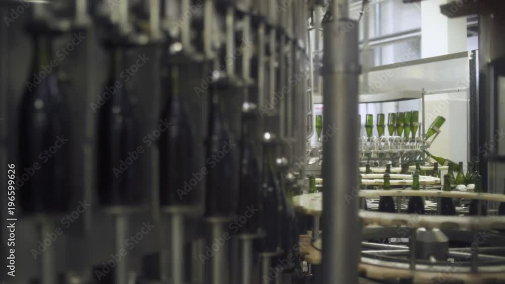 Factory of sparkling wines, view of bottles on conveyor in motion, production of champagne.
Factory of sparkling wines, view of bottles on conveyor in motion, production of champagne.