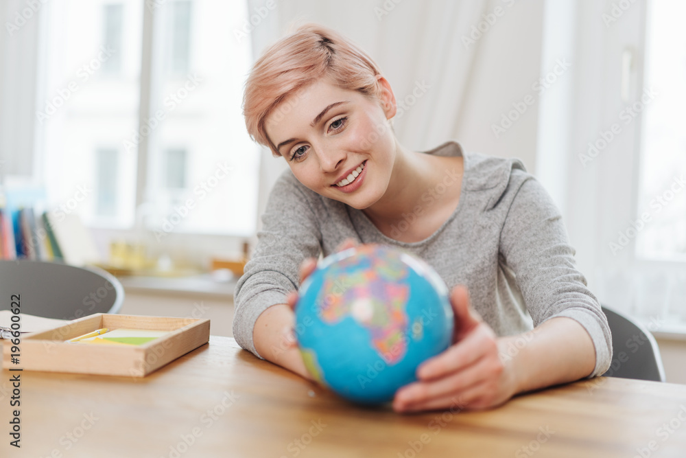 Young woman holding a world globe in her hands Young woman holding a world globe in her hands