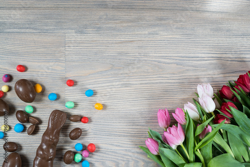 Delicious chocolate easter eggs ,bunny and sweets on dark wood background