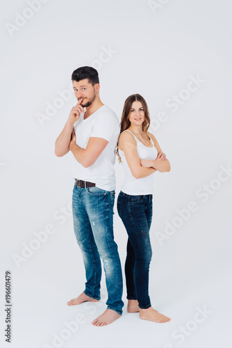 Attractive young couple standing back to back