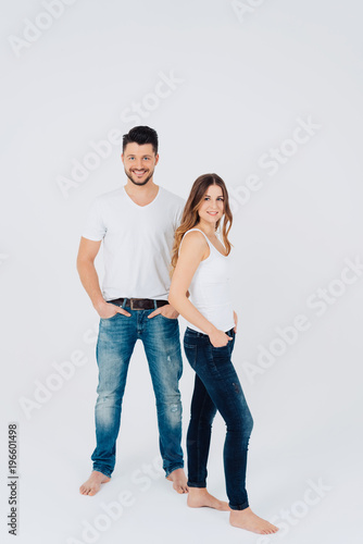Trendy young barefoot couple in denim jeans