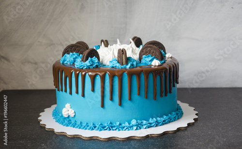 bright blue cream cake with sweets and cookies