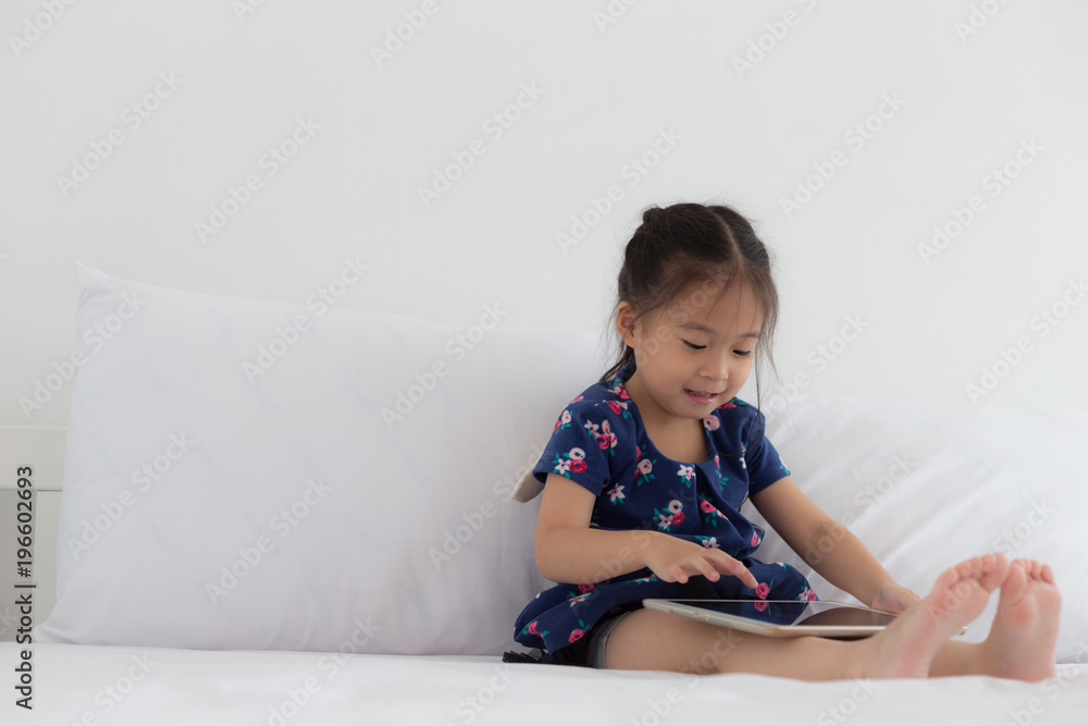 Children playing tablet in bedroom with copy space Children playing tablet in bedroom with copy space