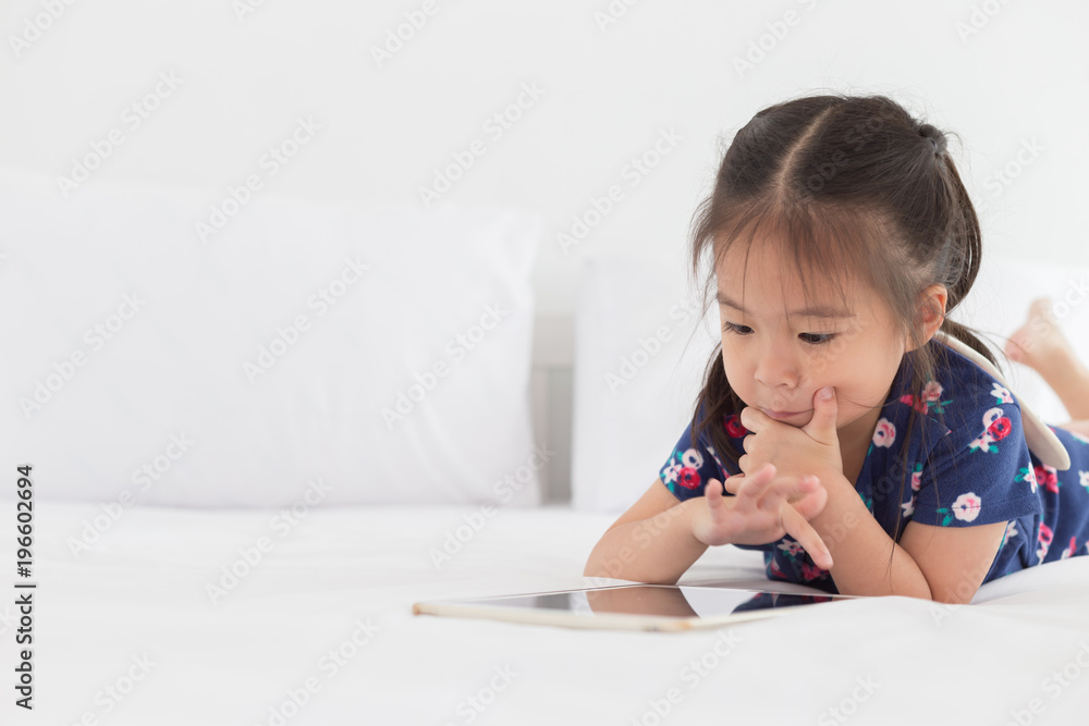 Children playing tablet in bedroom with copy space Children playing tablet in bedroom with copy space