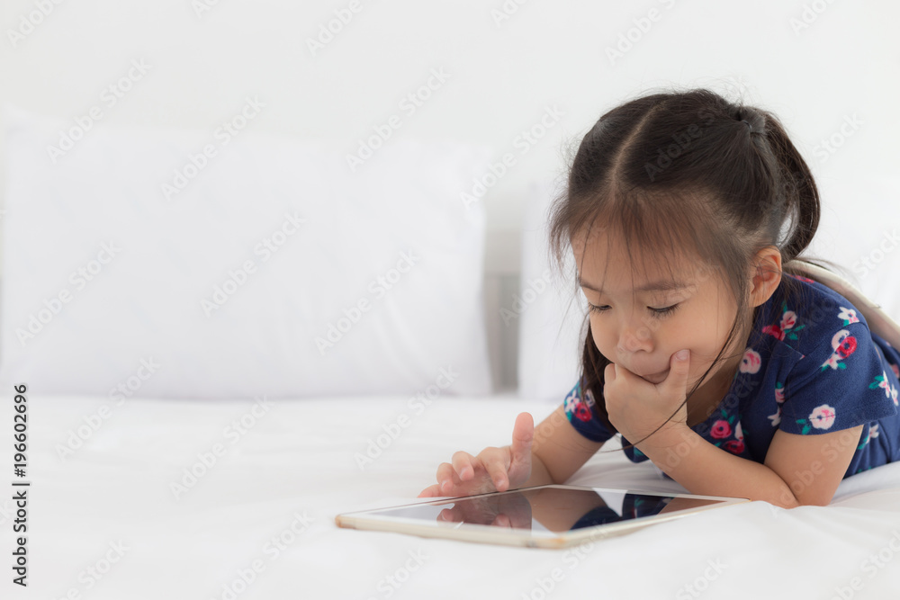 Children playing tablet in bedroom with copy space Children playing tablet in bedroom with copy space