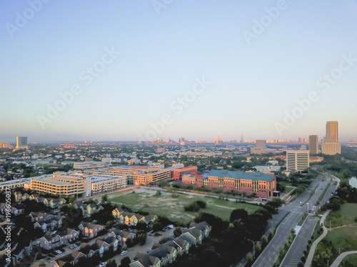 Aerial view Fourth Ward district and Alley Parkway west downtown Houston, Texas, USA. Row of apartment complex, office buildings and midtown skyline are in the distance. photo