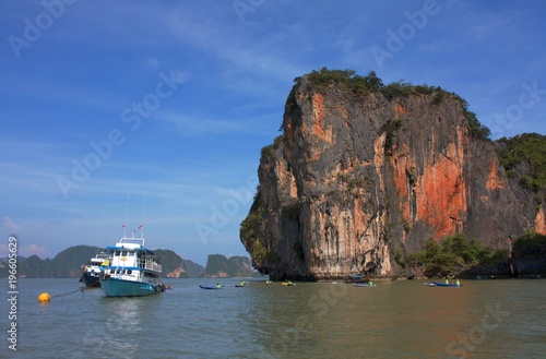 Beautiful place- tourist ship surrounded by kayaks that are waiting for tourists photo