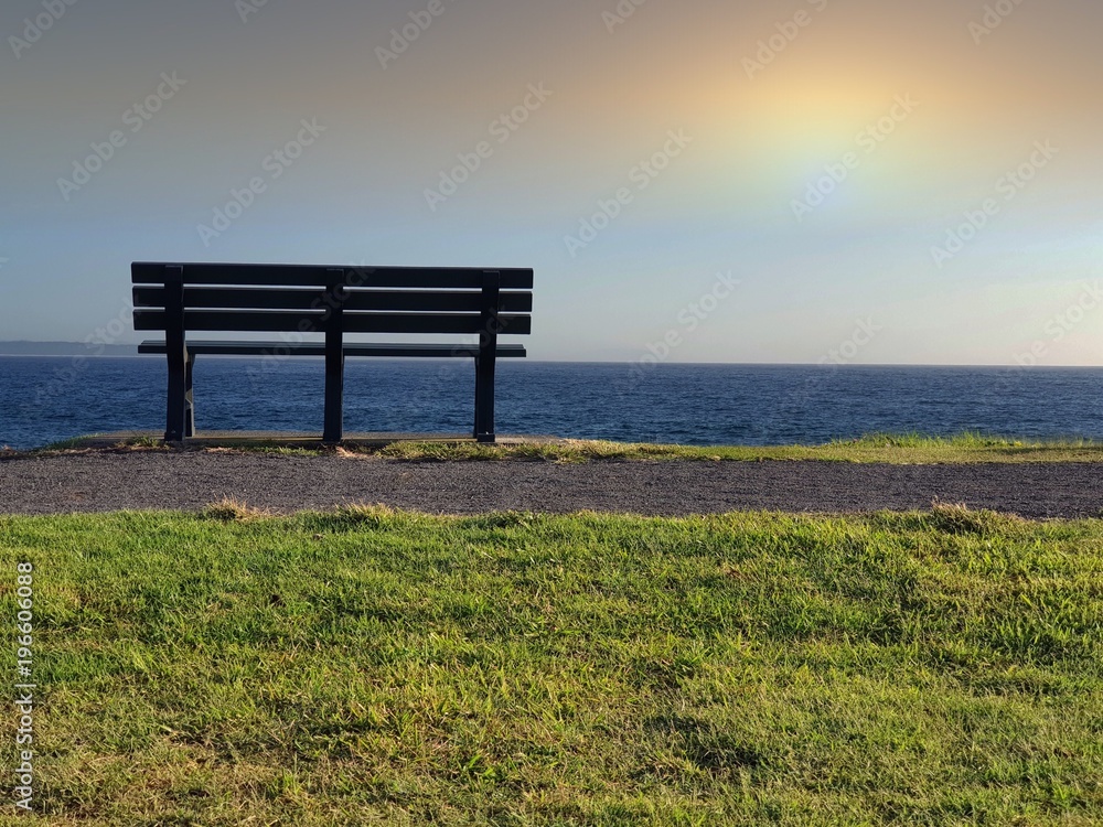 Single park bench on the horizon
